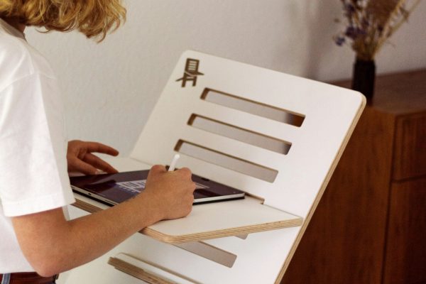 a young girl is working on a model of a house